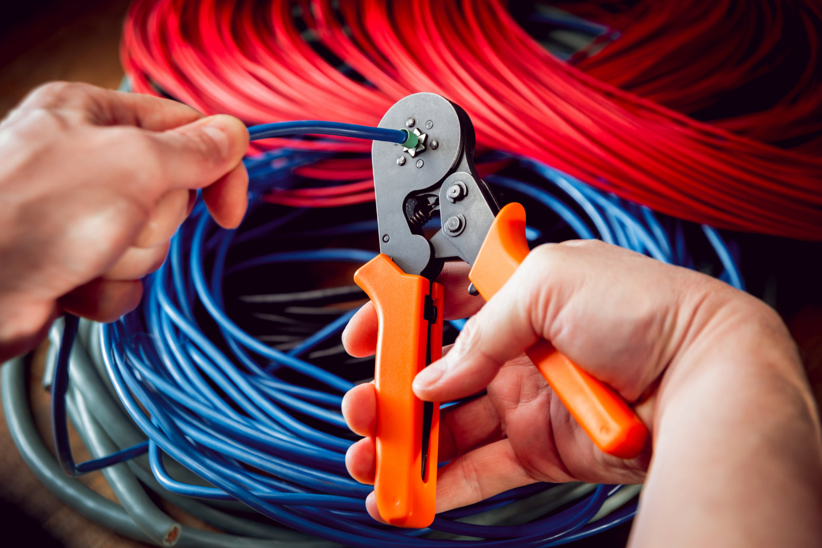 Electrical equipment. Electricity cable and crimper. Background